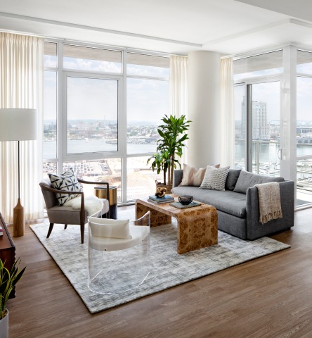 Modern and light living room with a panoramic view of Baltimore City from above at the Liberty apartments in Harbor East
