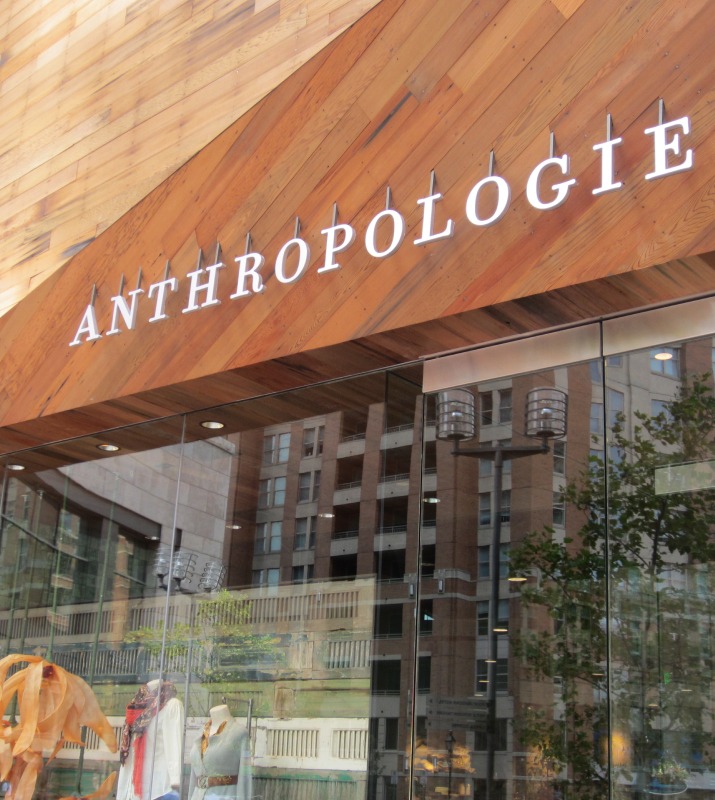 Anthropologie storefront in the center of Harbor East featuring large glass windows and a creative clothing display