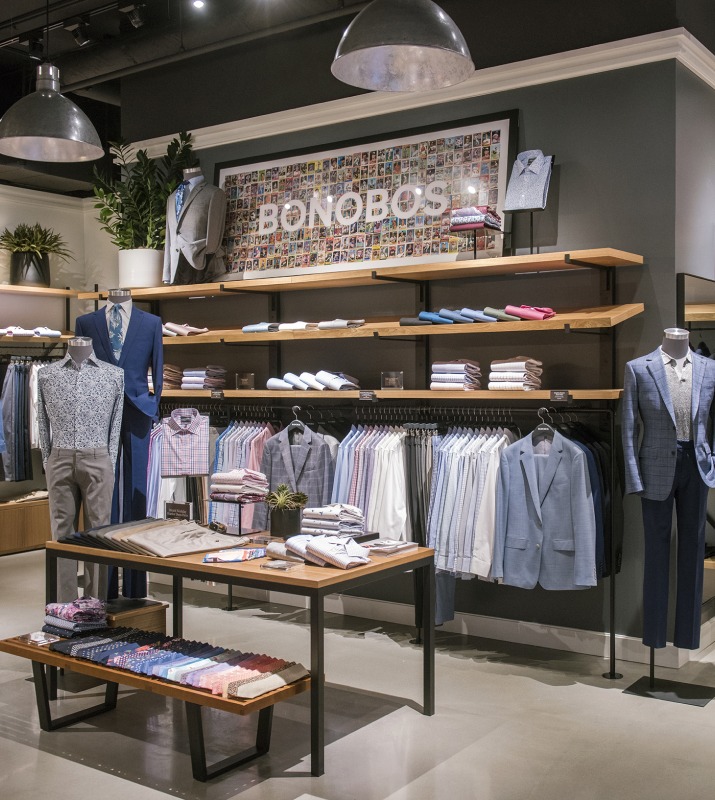 Interior of Bonobos menswear retailer featuring display of ties, blazers and shirts