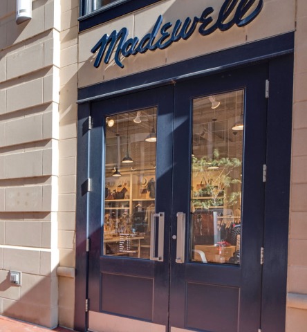 Entrance doors to Madewell, a modern clothing shop in the center of Harbor East