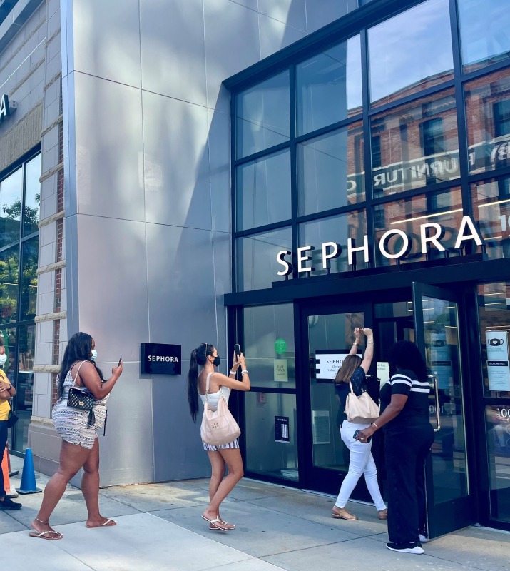 A line of people enter Sephora in Harbor East to shop for makeup and beauty supplies