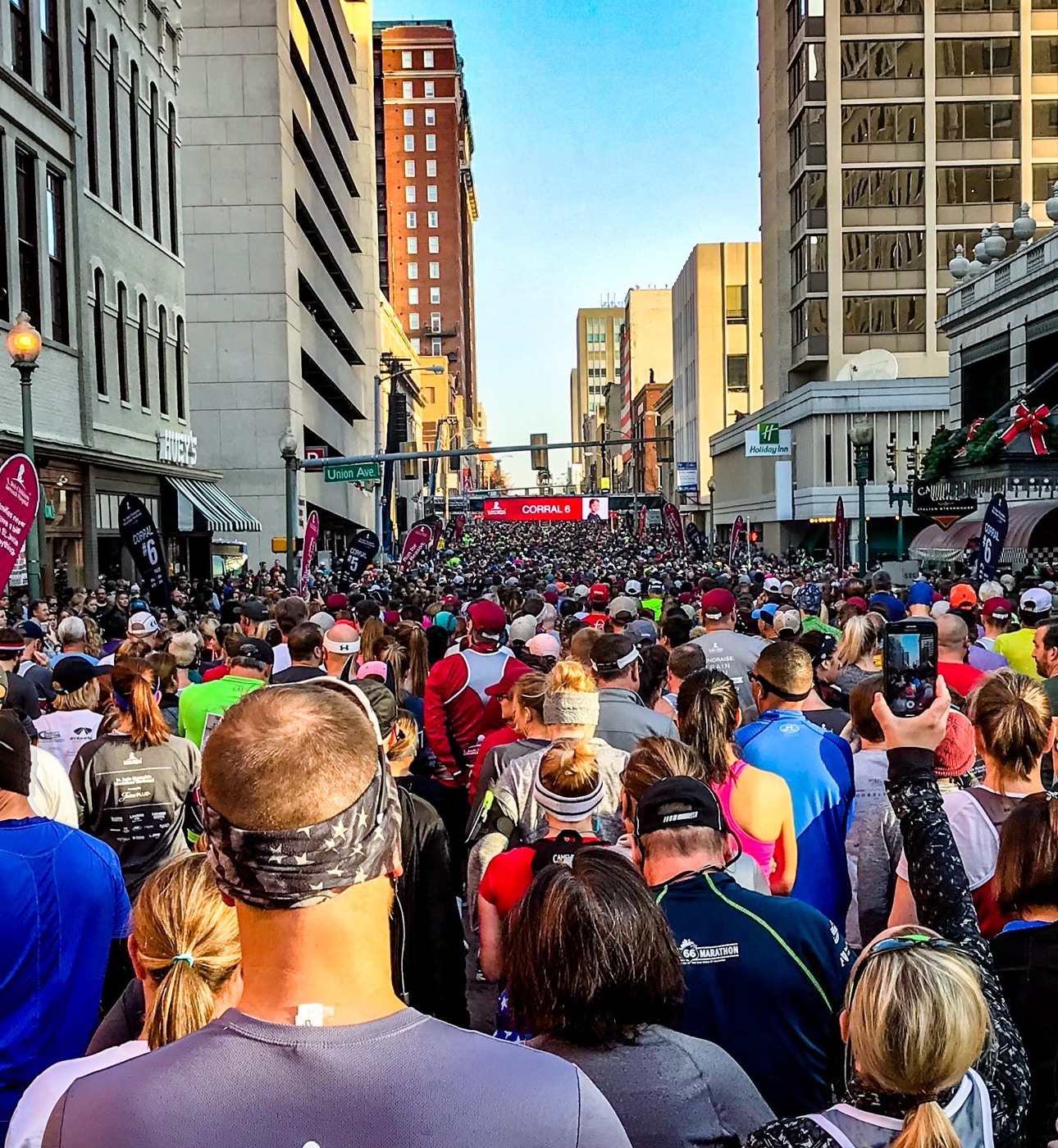 Huge group of runners crowded on city street running together for a marathon event