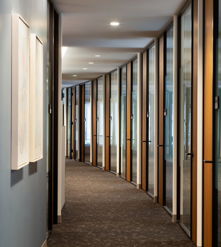 Office hallway that curves to the left with several doors inside of the 1001 Fleet Office Building