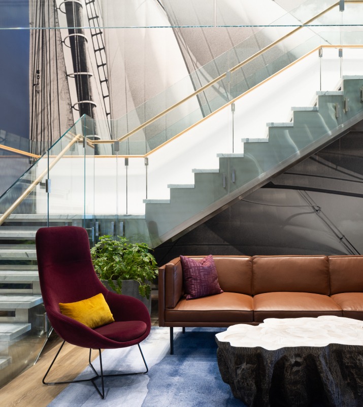 Lobby of 100 International Office Building featuring a grand glass staircase and comfortable, chic seating