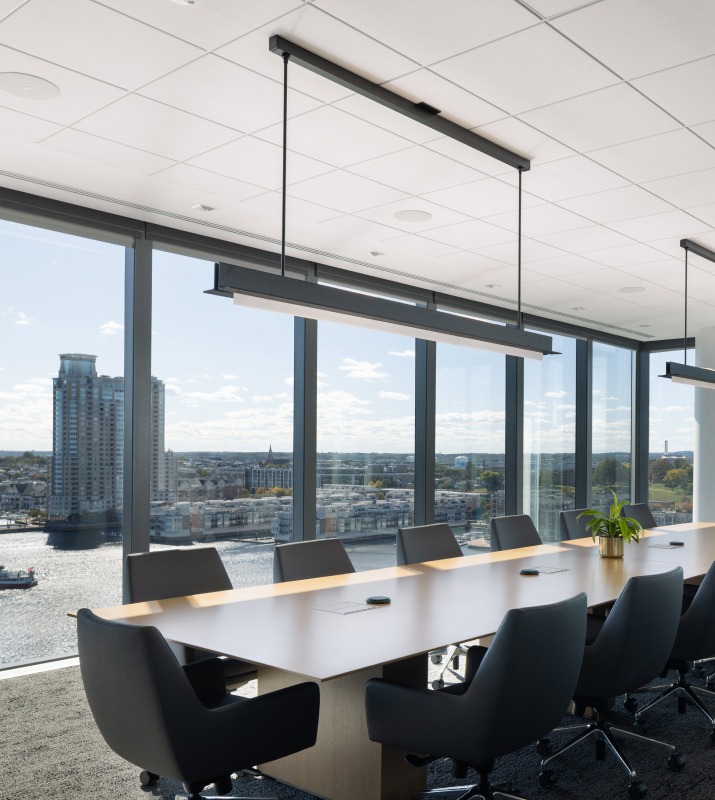 Conference room with several chairs and a large table with a view of Baltimore Harbor from above