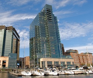 Glass high rise office building 100 International from the marina on a sunny day in Harbor East